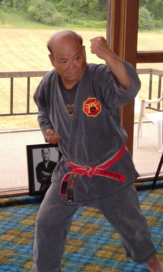 Eizo Shimabukuro O'Sensei in a fighting stance wearing his red belt