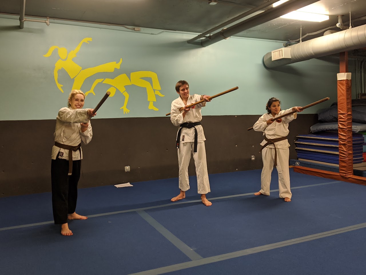 Students practicing bo in the dojo