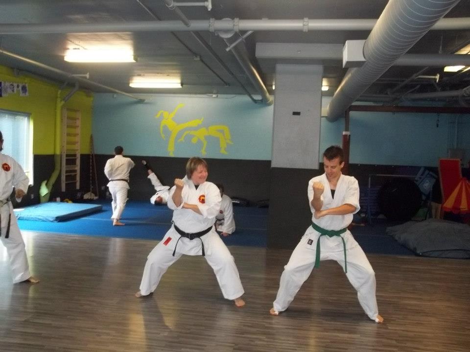 Two students holding fighting stances during class