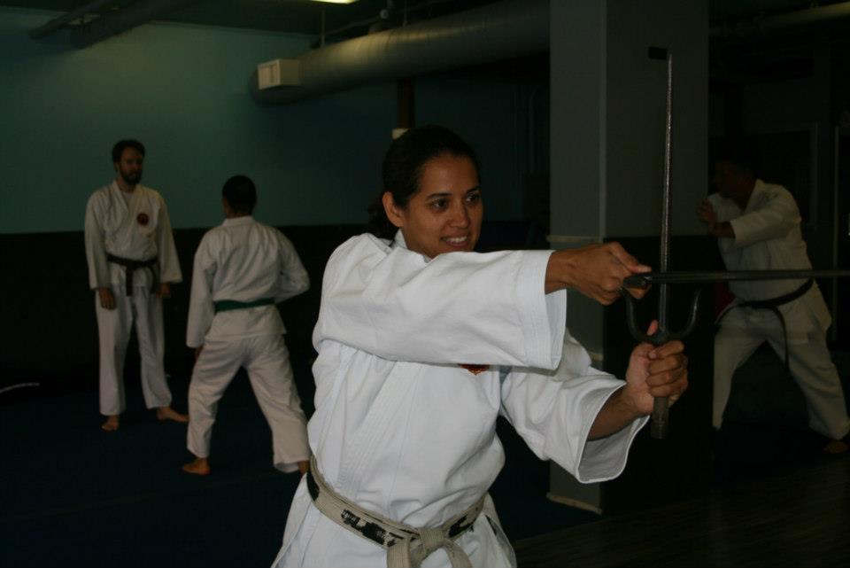 A student practicing with sai