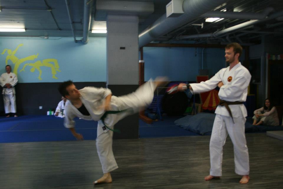 Sparring practice — a high kick to a partner