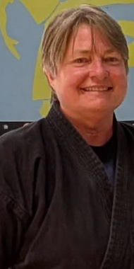 Deb Lee Sensei in a white karate gi